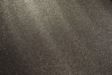 Oblique rays of light on a black surface. Bokeh, dust particles, reflection and magical glow....
