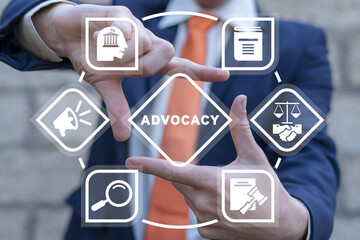 Man using virtual touch interface sees word: ADVOCACY. Business advocacy and lawyer consulting...