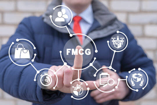 Businessman using virtual touch screen presses abbreviation: FMCG. FMCG or Fast Moving Consumer Goods Digital Business Concept.