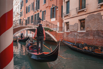 Fototapeta na wymiar Experience the timeless beauty of Venice with this stunning image of gondolas gliding through the picturesque canals, showcasing the city's unique charm and historic atmosphere.