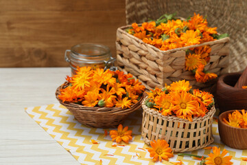 Beautiful fresh calendula flowers on white wooden table