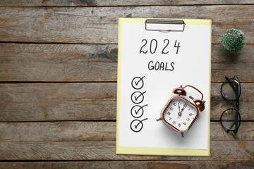 Paper sheet with empty to do list, alarm clock and eyeglasses on wooden background