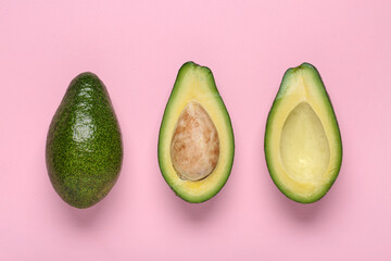 Fresh ripe avocados on pink background