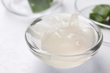 Aloe vera gel in bowl on white background, closeup