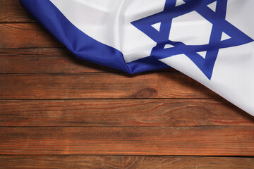 Flag of Israel on wooden background, above view and space for text. National symbol