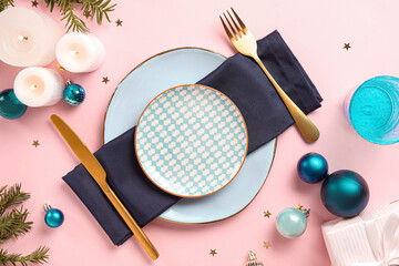 Beautiful table setting for Christmas dinner with decorations on pink background