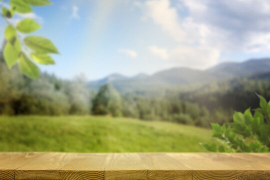 Empty wooden table in mountains on sunny day. Space for design