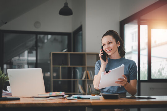 Business woman using business paper for doing math finance on office desk, tax, report, accounting, statistics, and analytical research concept