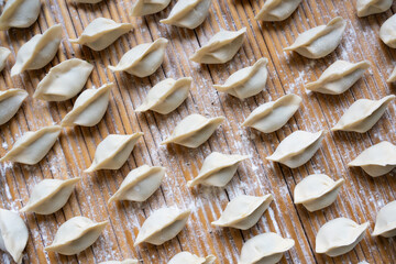 making dumplings in the kitchen. traditional food raw dimplings	
