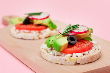 Rice Cake Sandwiches with Avocado, Tomato, Cottage Cheese, Olives and Radish on Wooden Cutting Board. Easy Breakfast. Diet Food. Quick and Healthy Sandwiches. Crispbread with Tasty Filling