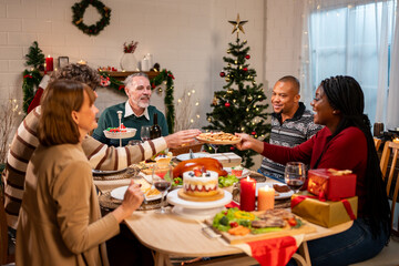 Multi-ethnic big family celebrating Christmas party together in house.