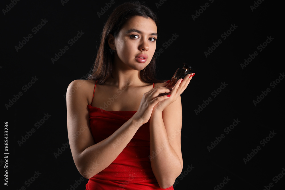 Poster attractive young woman with perfume on dark background