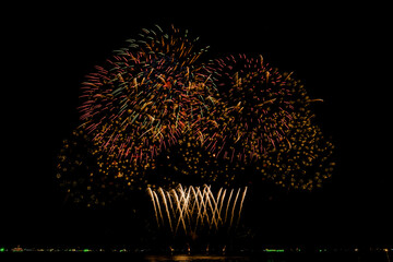 Fireworks show under defocus or blur concepts with isolated black background at night, this...