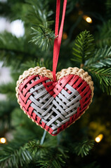 Christmas tree with decorative heart on blurred background, closeup. Festive decoration