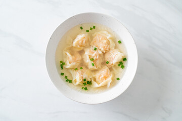 shrimp dumpling soup in white bowl