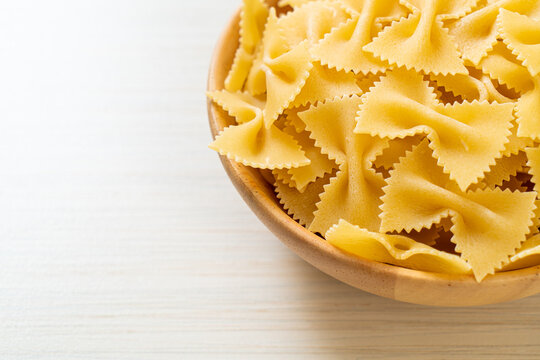 Dry uncooked farfalle pasta in bowl