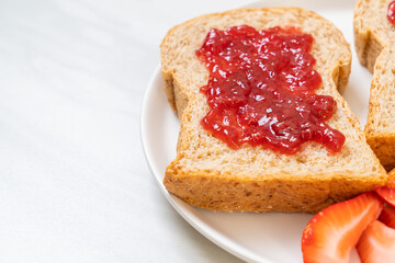 whole wheat bread with strawberry jam and fresh strawberry