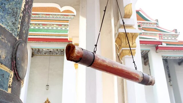 The hanging wooden log - beam used for strike at bell in a Buddhist temple