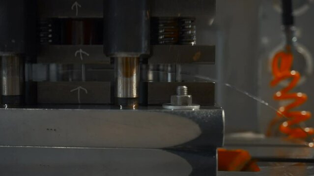 A large industrial punch press forming sheet metal parts. Creative. Close up of sheet metal stamping machine.