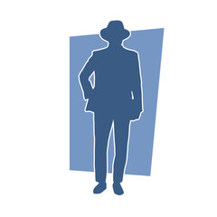 Silhouette of a gentleman in suit and wearing fedora hat 