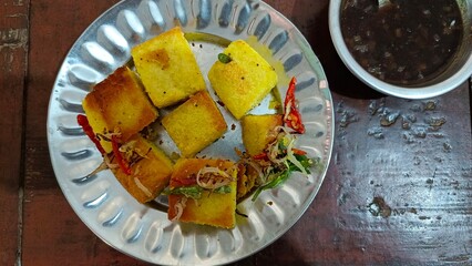 Indian Gujarati cuisine Dhokla on the plate with Imli Chutney