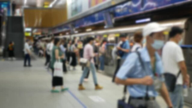 out of focusing blur view of passengers traveller waiting for arrival train and get on subway train commuter in rush hour business time in taipei