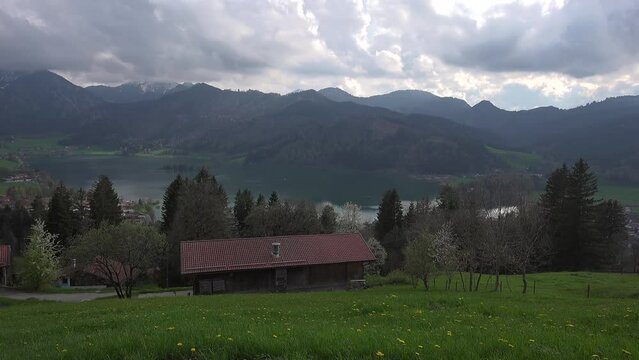 View of mountains and mountain lake in summer. Beautiful town of Schliersee in Bavaria, Germany, Europe. Lake Schliersee in bavarian mountain range. Upper Bayern. Panarama auf den Schliersee. 
