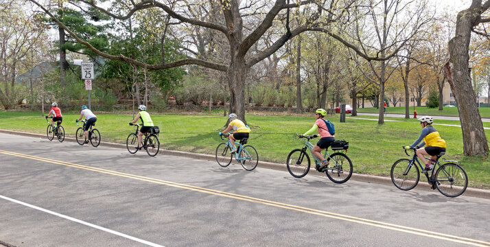 Bicycle group riding on the Mississippi River Boulevard near the monument. St Paul Minnesota MN USA