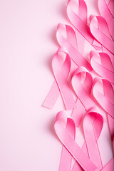 Pink colored ribbon isolated on pink background. Symbol of breast cancer awareness. healthcare and medicine concept. Preventive measures. Women health