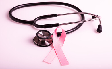 Pink colored ribbon and stethoscope. Symbol of breast cancer awareness. healthcare and medicine concept. Preventive measures. Women health