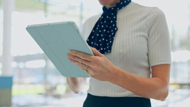 Tablet, airport and hands of flight attendant scrolling for travel schedule online, internet or website at terminal. Information, technology and employee check international or global business class