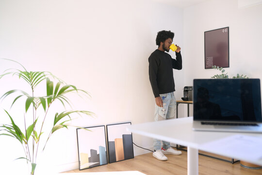 man drinking coffee during work break at office. Relaxed moment during business work