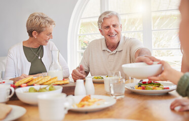 Breakfast, family and hungry with senior couple, cooking.and happy together in a home. Love, support and care on a dining room with a smile and food with bonding in the morning with fruit in a house