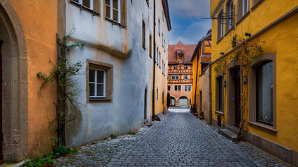 Historic homes along narrow cobblestone alley in historic Rothenberg city