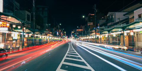Business street with streaks of vehicle lights at world famous heritage site Gion districtin Kyota...
