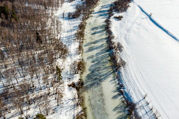View from a high altitude of an icy river bed in the winter season