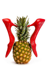 Women's red high-heeled shoes with pineapple on a white background