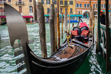 A colorful empty gondola in Venice at a wharf