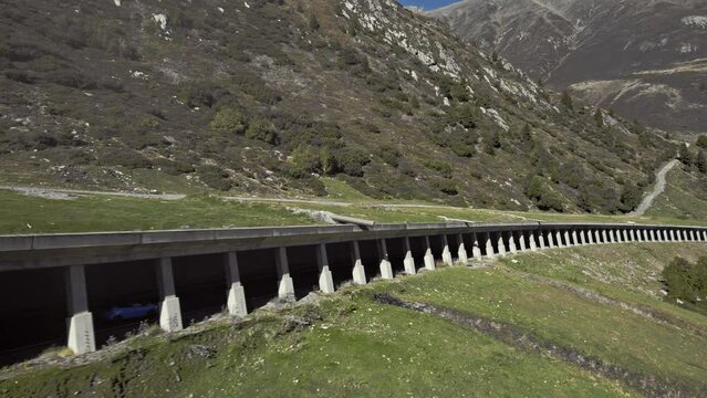 Tracking car driving in rock shed,  beautiful calming mountain alps summer sunny landscape, K&uuml;htai, aerial