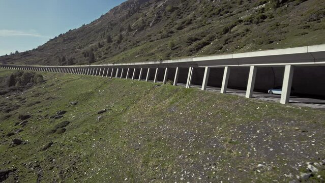Aerial car driving in tunnel in beautiful calming mountain alps summer sunny landscape, K&uuml;htai, Austria