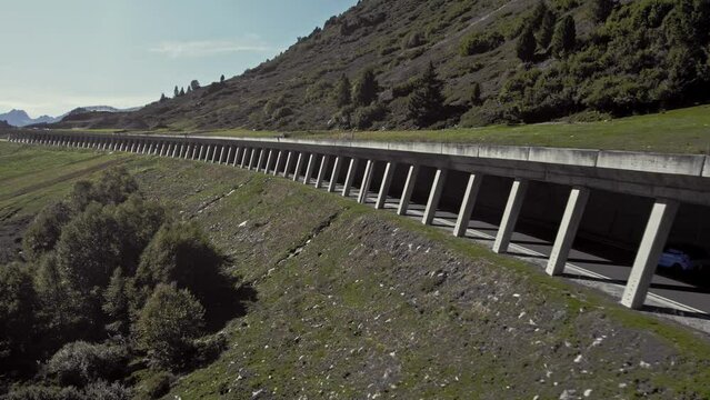 Aerial car driving in rock shed,  beautiful calming mountain alpsine summer sunny landscape, K&uuml;htai, Austria
