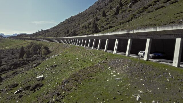 Aerial car driving in rock shed,  beautiful calming mountain alps summer sunny landscape, K&uuml;htai, Austria