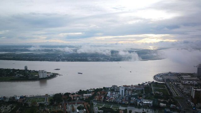 Aerial timelapse that pans over the Mekong River that is flowing through Phenom Penh, Cambodia in the morning.