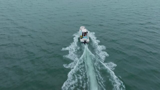 Aerial tracking shot of a scientific boat sailing to the location at Sete