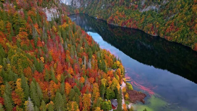 Aerial drone view over Lake Toplitz. Alps. Stunning colours in the trees, mountain reflected in the lake surface