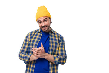 cute positive young hipster man in cap and shirt on white background with copy space