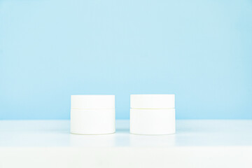 Cosmetic product on light background cosmetic bottles isolated on blue