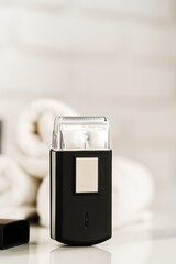 Electric shaver for men in a bathroom close up