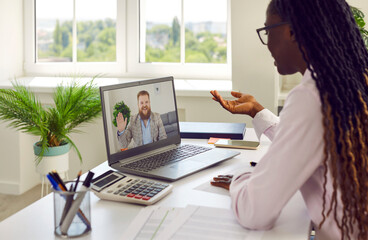 Diverse business team having remote work meeting via video call. Young African American woman...