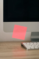 Blank pink sticky notes on computer screen